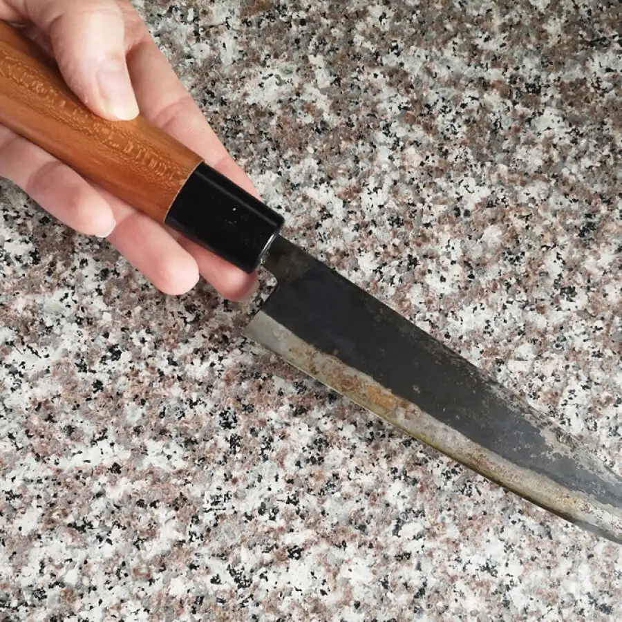Worn kitchen knife on a granite countertop