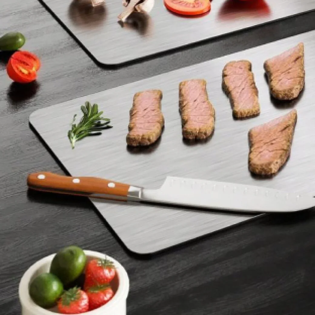 Kitchen knife and sliced steak on a Katori titanium cutting board