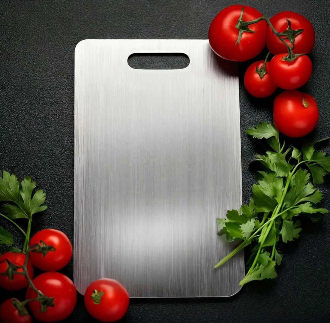 Katori titanium cutting board with fresh tomatoes and parsley on a dark countertop