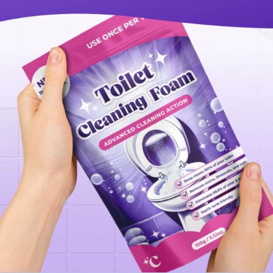 Hands holding a pouch of FizzClean toilet cleaning foam in a bathroom